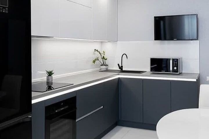 A modern kitchen with white and dark grey units