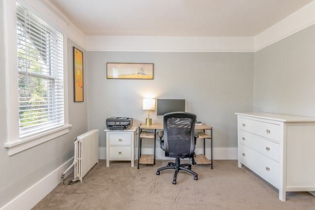 A small home office with a desk by the window